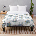 Cozy plush blanket featuring a sewing machine and floral embroidery pattern