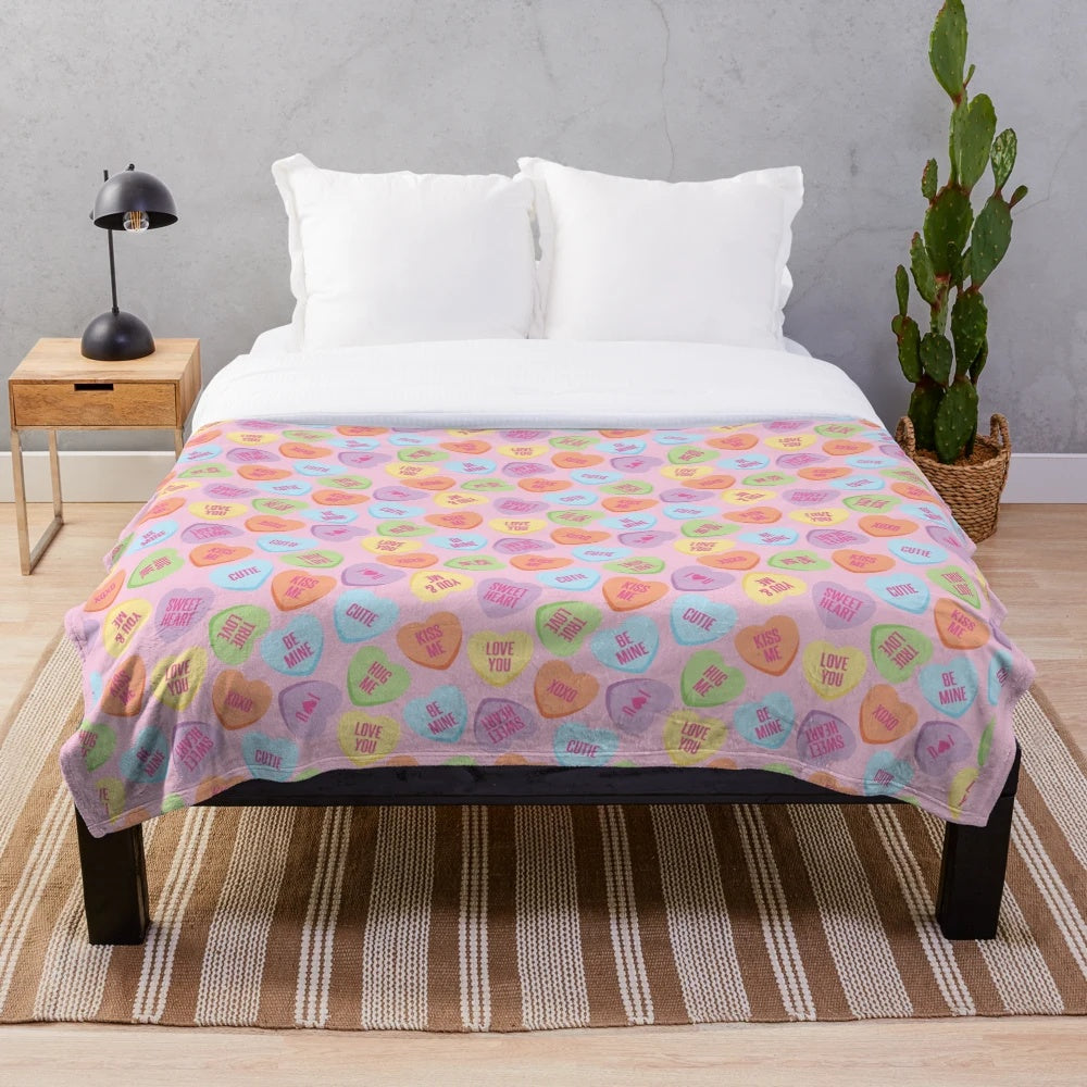 Soft plush blanket with pastel conversation hearts design