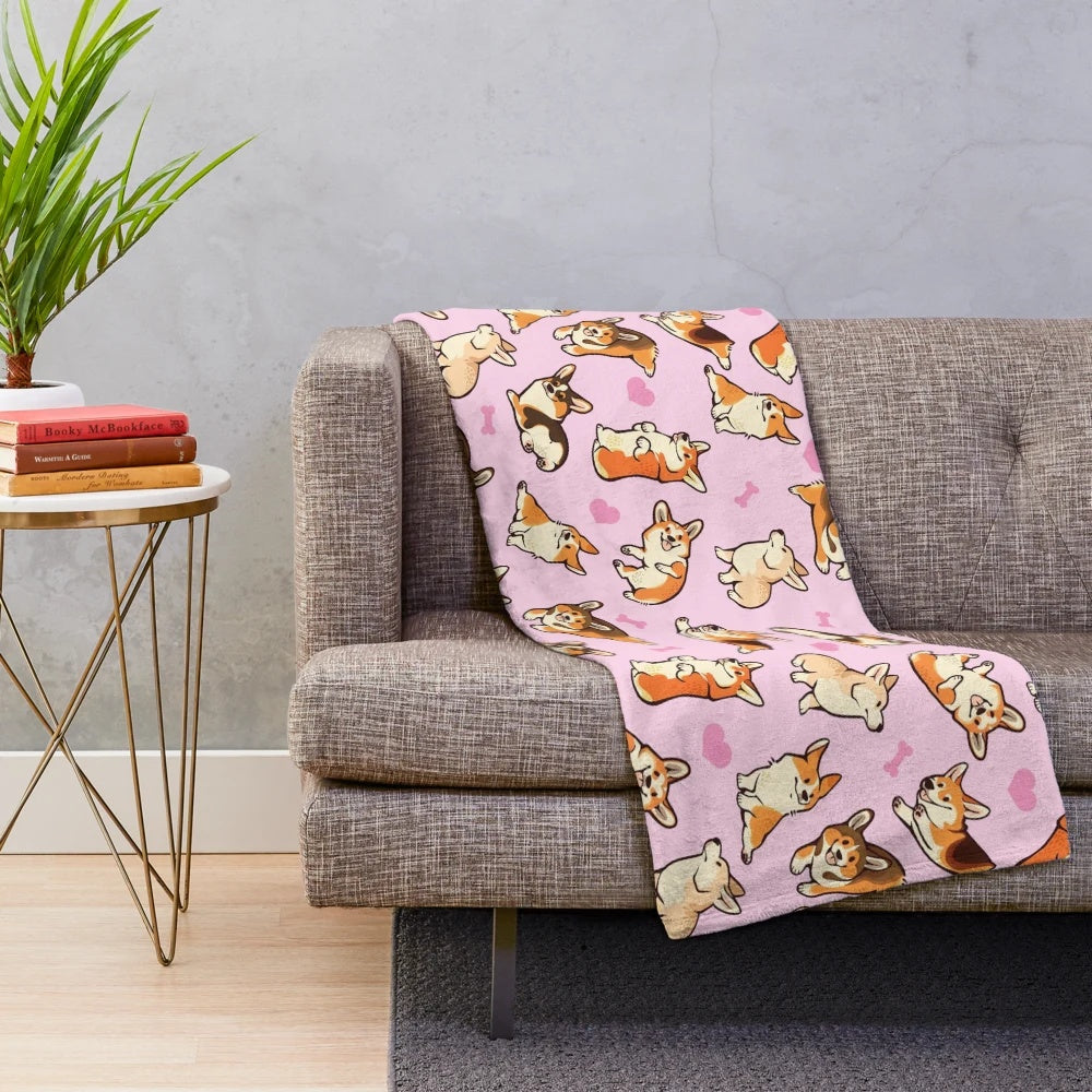 Soft and cozy plush blanket featuring a cute pattern of pembroke welsh corgis in pink