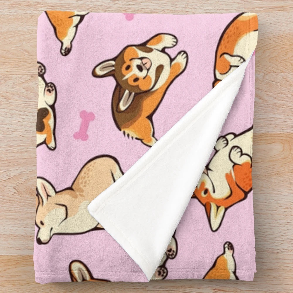 Soft and cozy plush blanket featuring a cute pattern of pembroke welsh corgis in pink