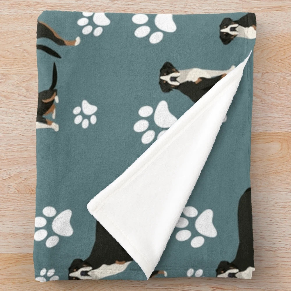 Plush gray blanket with greater swiss mountain dog paw print design