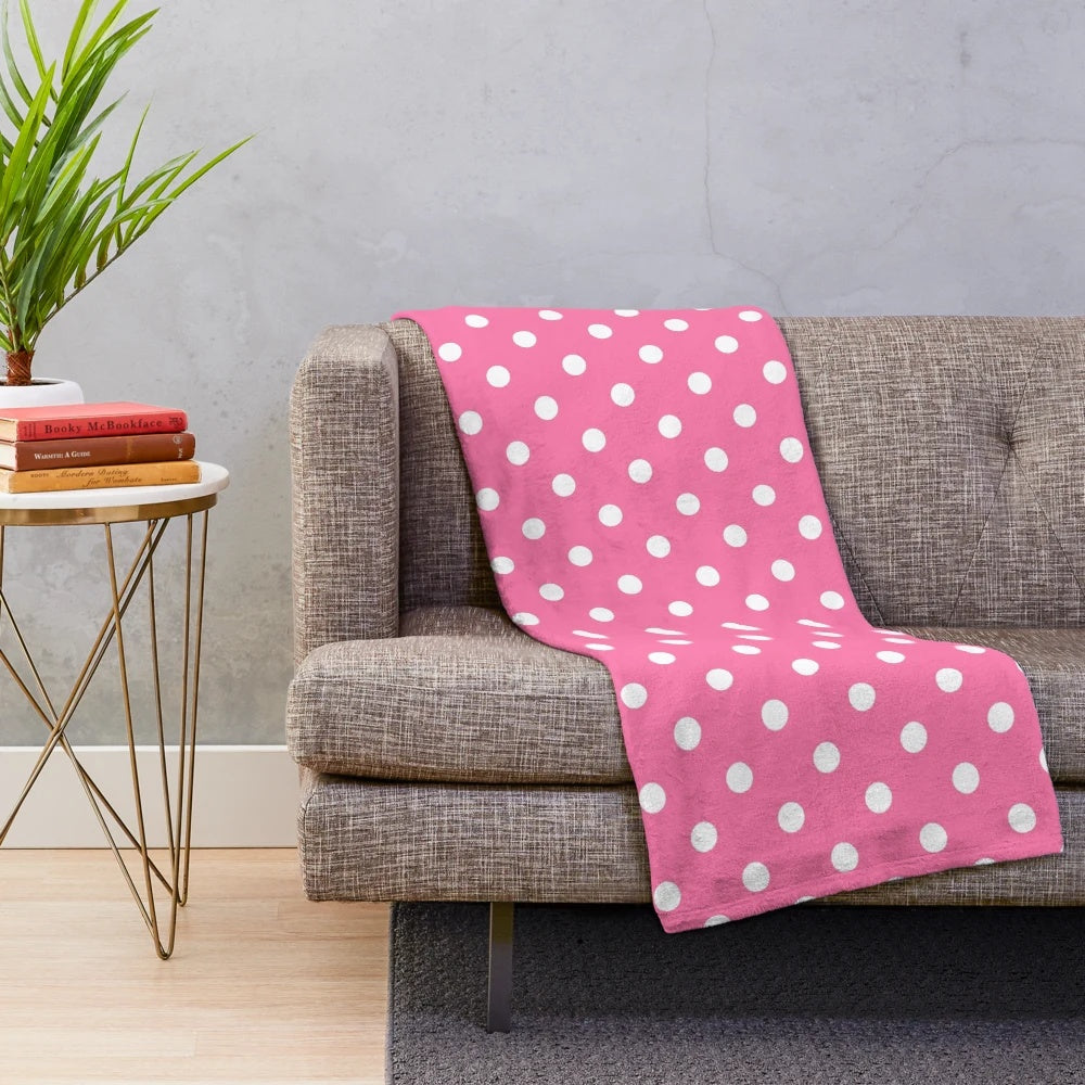 Soft and cozy plush blanket with a pink and white polka dots pattern