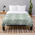 Soft and cozy sage green plush blanket with a beautiful floral daisy pattern
