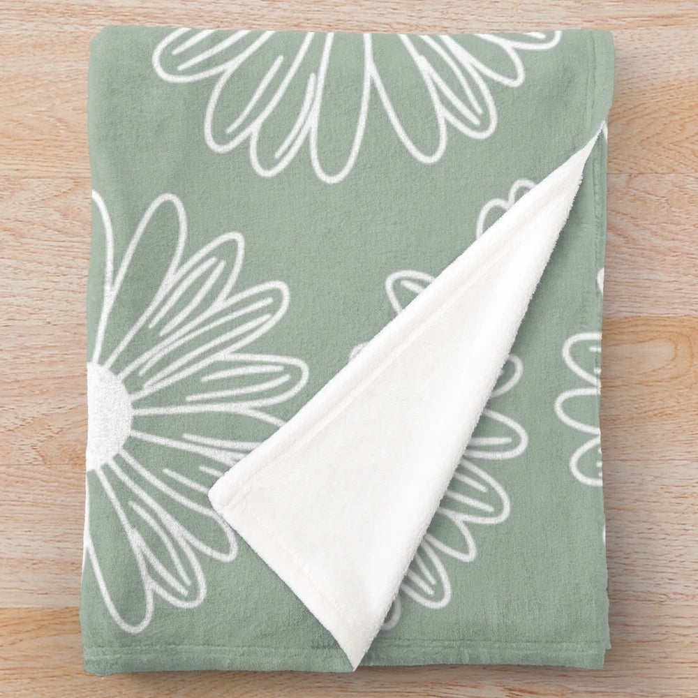 Soft and cozy sage green plush blanket with a beautiful floral daisy pattern
