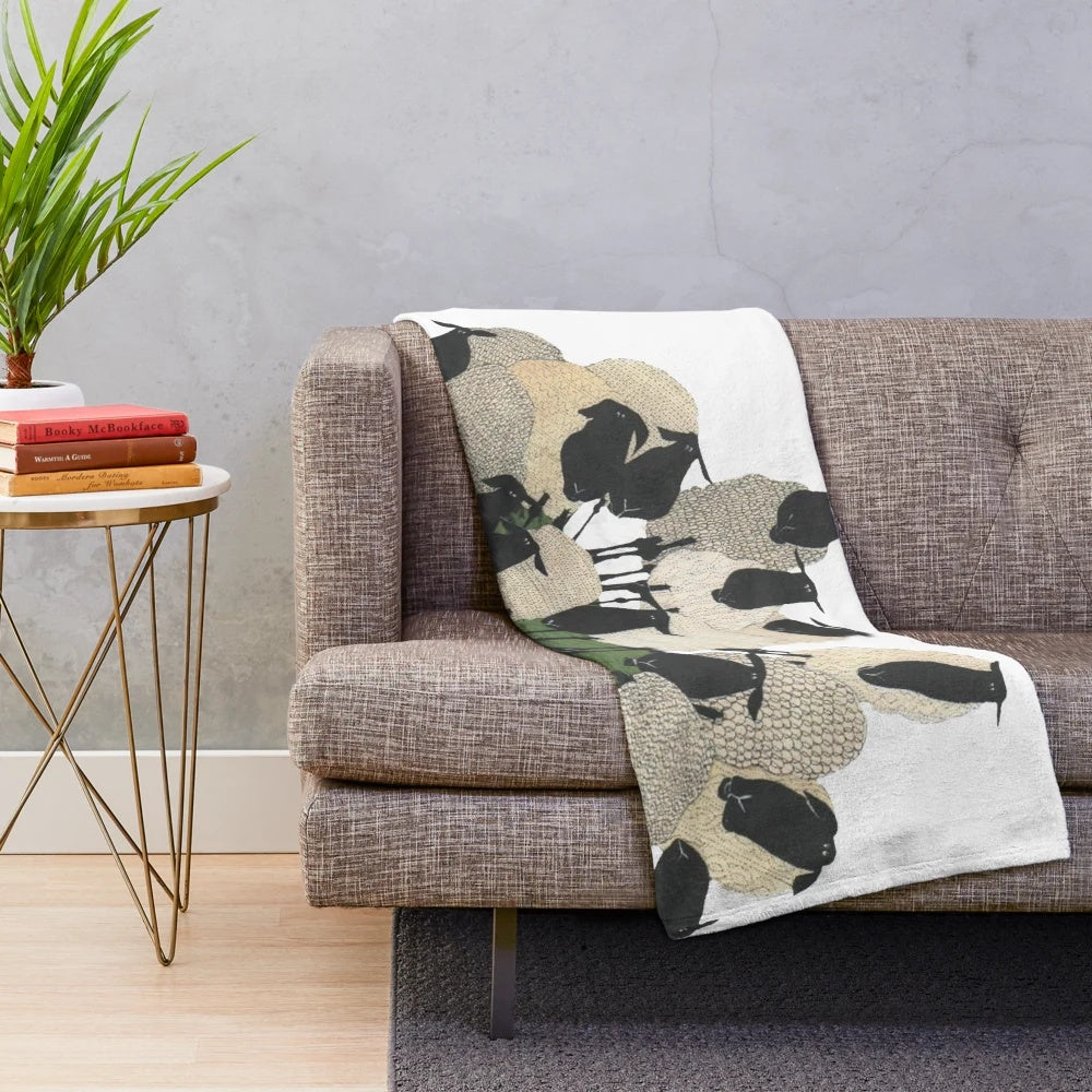 Soft and plush sheep-themed blanket with sheep on a hill design
