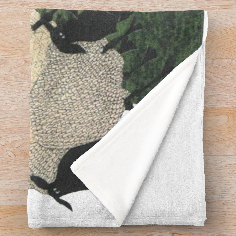 Soft and plush sheep-themed blanket with sheep on a hill design