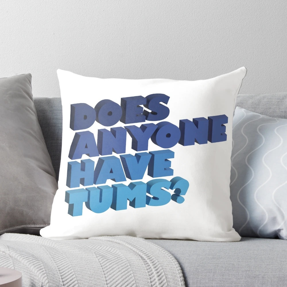A blue 3D pillow with the text "Does Anyone Have Tums?" in a fun, typographic design.