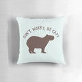 Capybara illustration on a soft, plush pillow with the text "Don't Worry, Be Capy