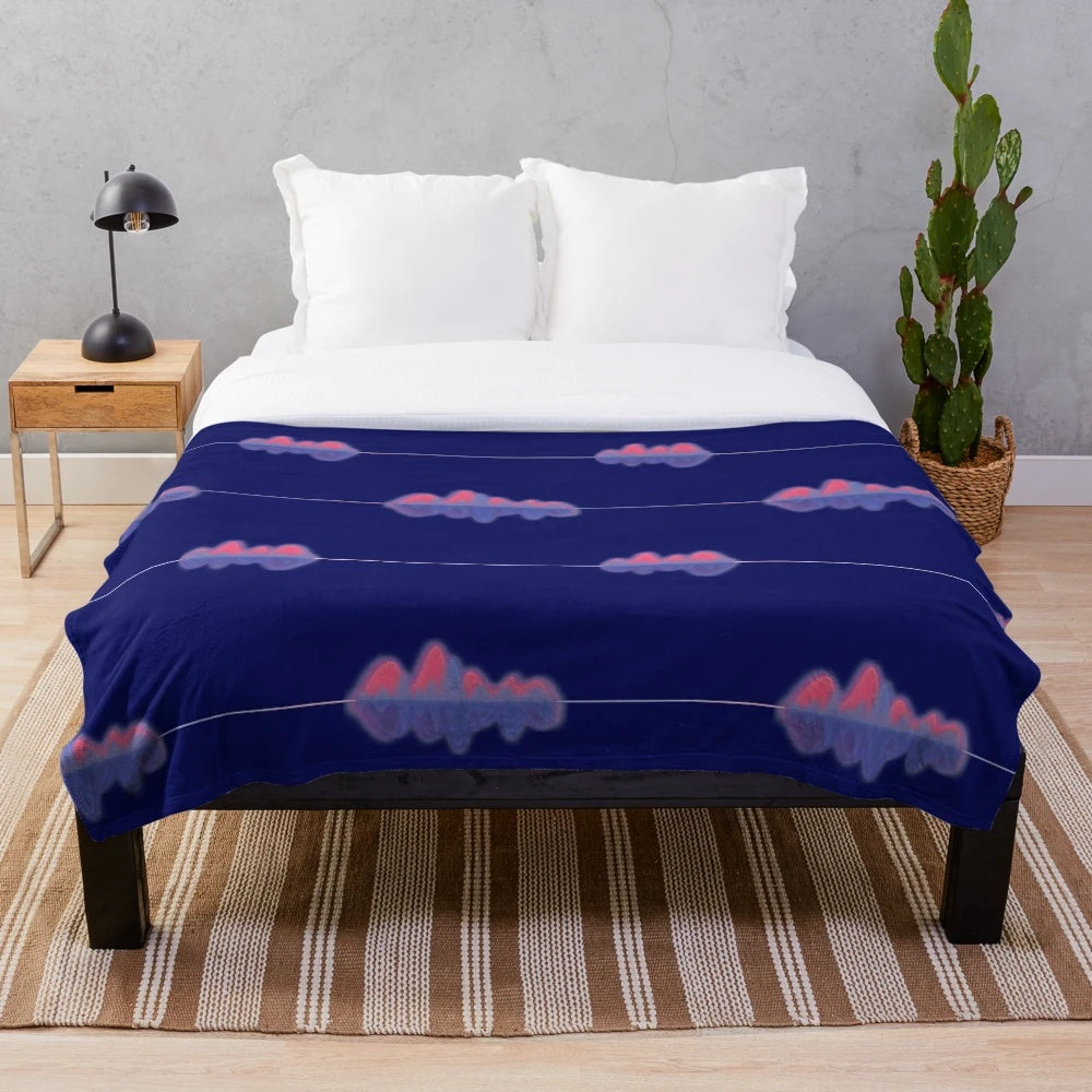 Plush blanket with an audio wave pattern in shades of pink, purple, and blue