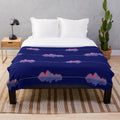 Plush blanket with an audio wave pattern in shades of pink, purple, and blue
