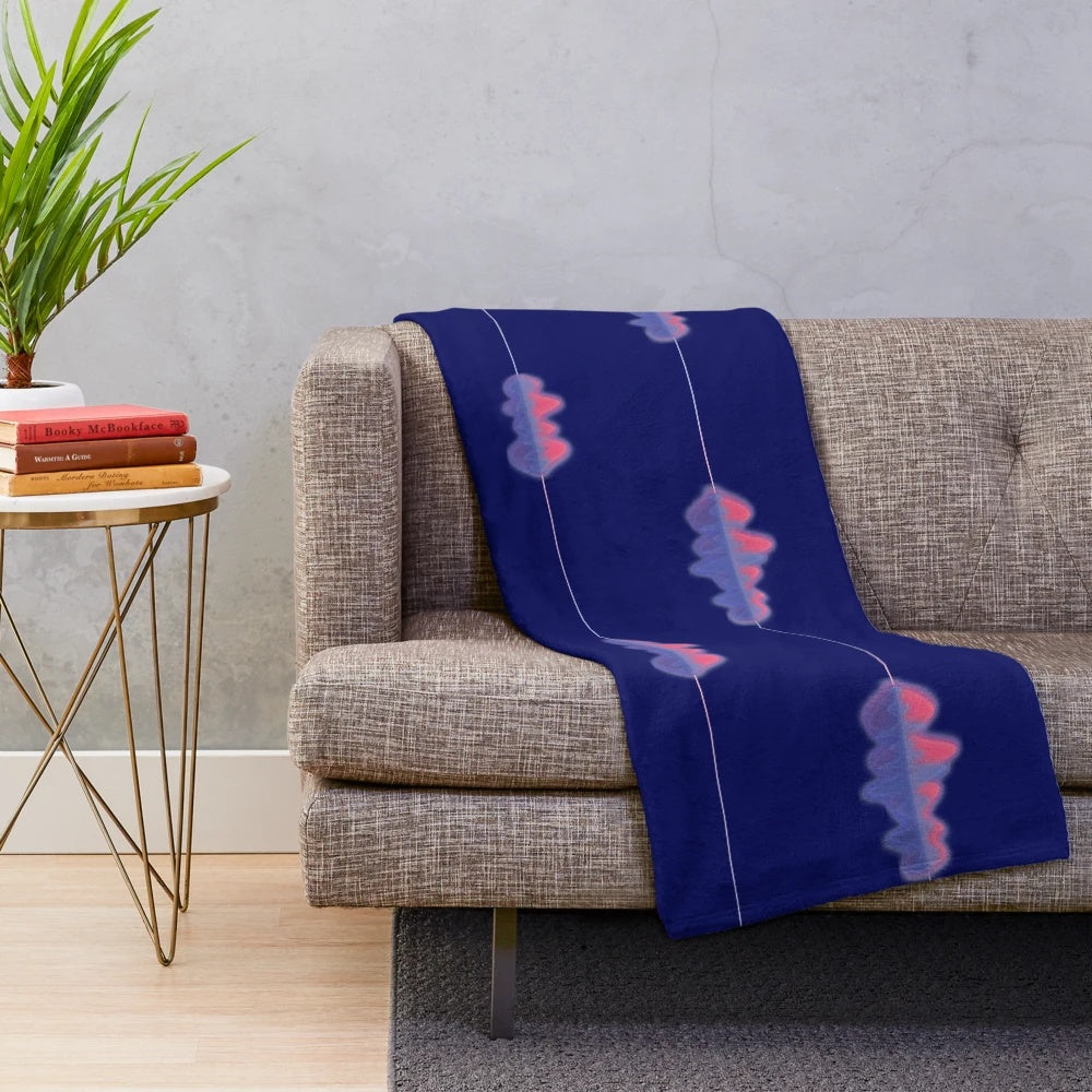 Plush blanket with an audio wave pattern in shades of pink, purple, and blue