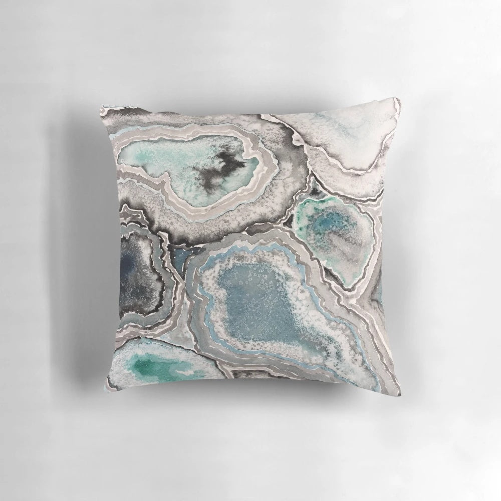 Blue teal decorative pillow with a natural, geode-inspired design