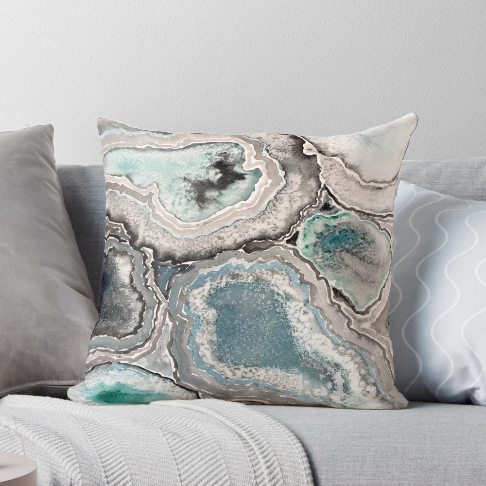 Blue teal decorative pillow with a natural, geode-inspired design