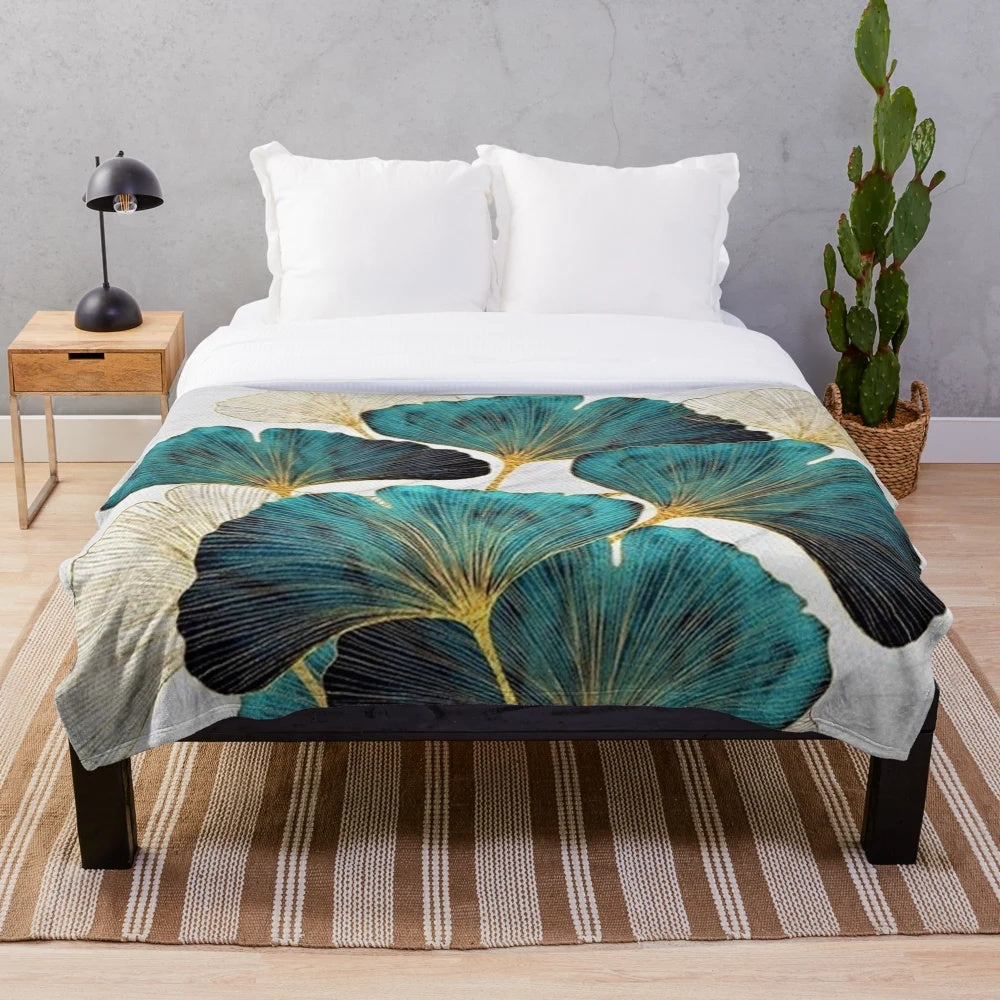 Soft, plush blanket featuring a beautiful ginkgo leaf pattern in shades of blue and yellow