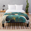Soft, plush blanket featuring a beautiful ginkgo leaf pattern in shades of blue and yellow