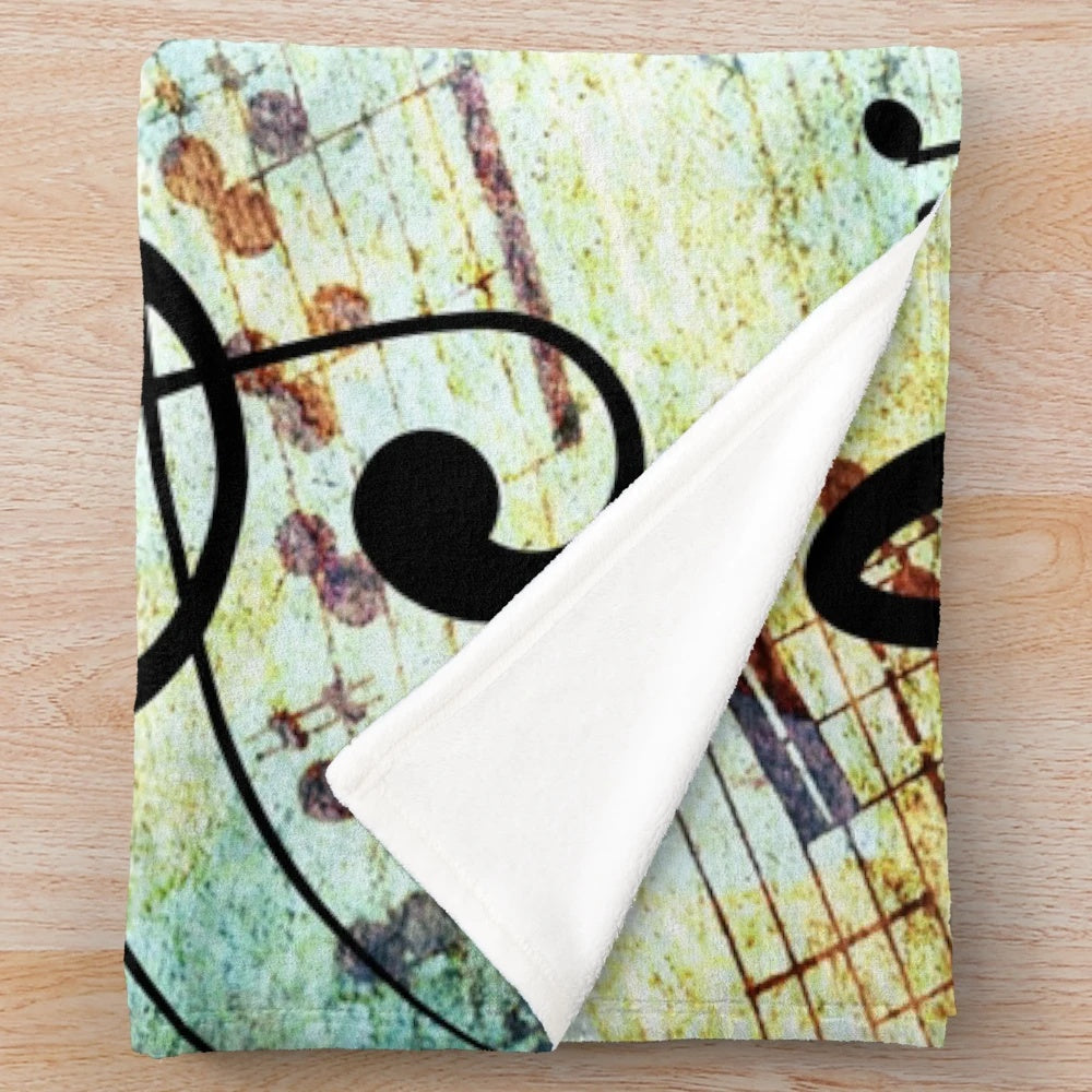 Music-themed plush blanket with musical notes and colors