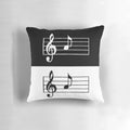 A black and white pillow featuring a simple musical note design, perfect for music lovers and minimalist decor.