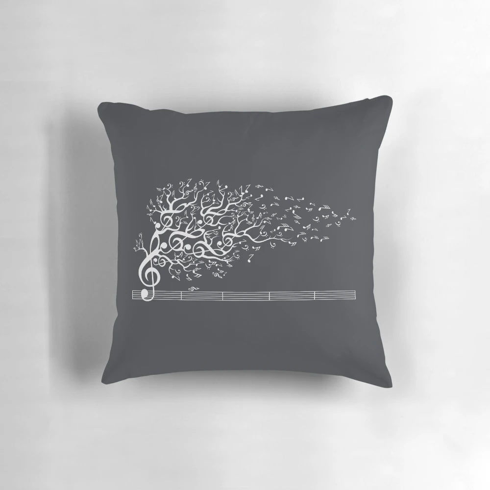 A white pillow with an artistic design featuring nature sounds and musical notes