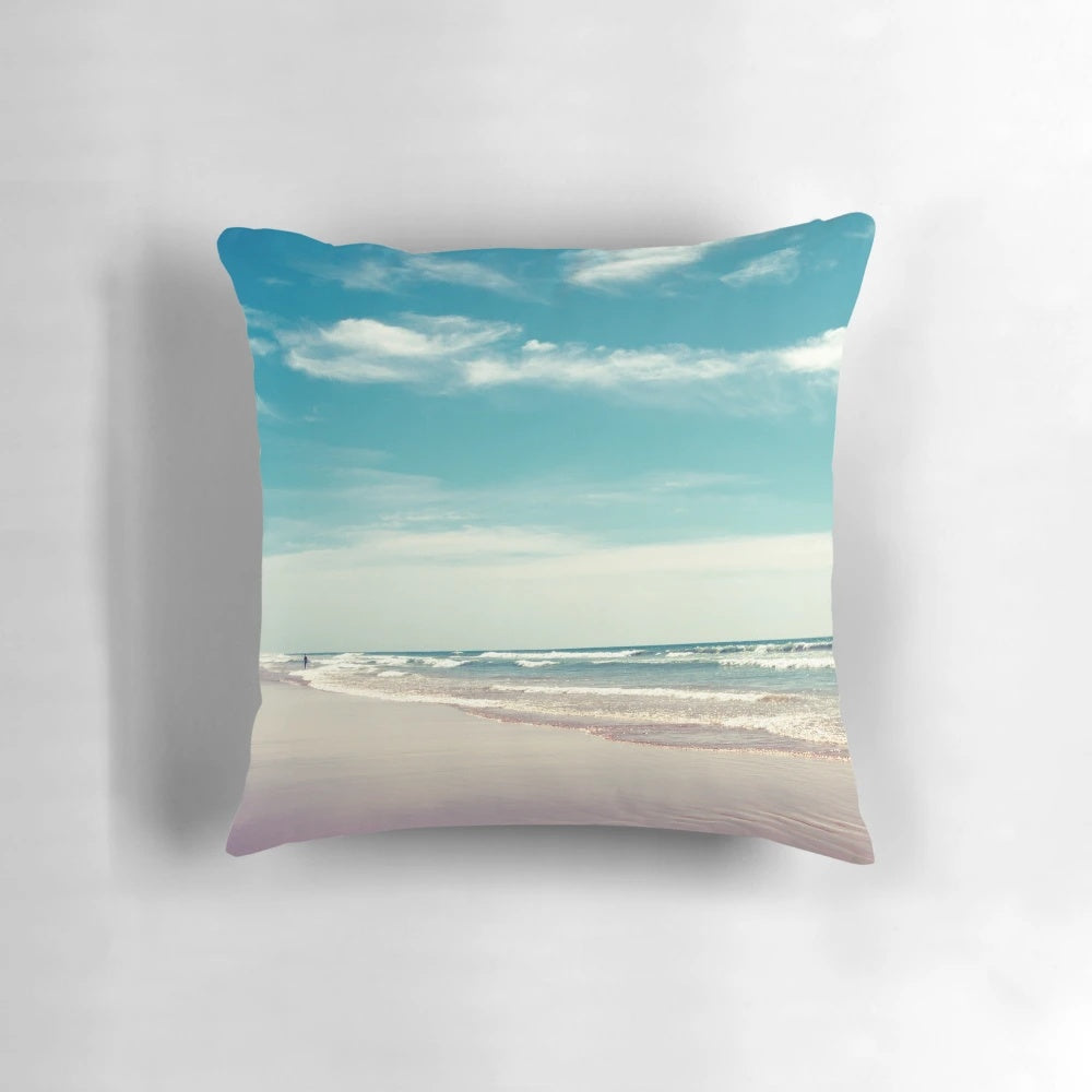 Soft, colorful pillow depicting a swimmer in a peaceful, tropical ocean scene.