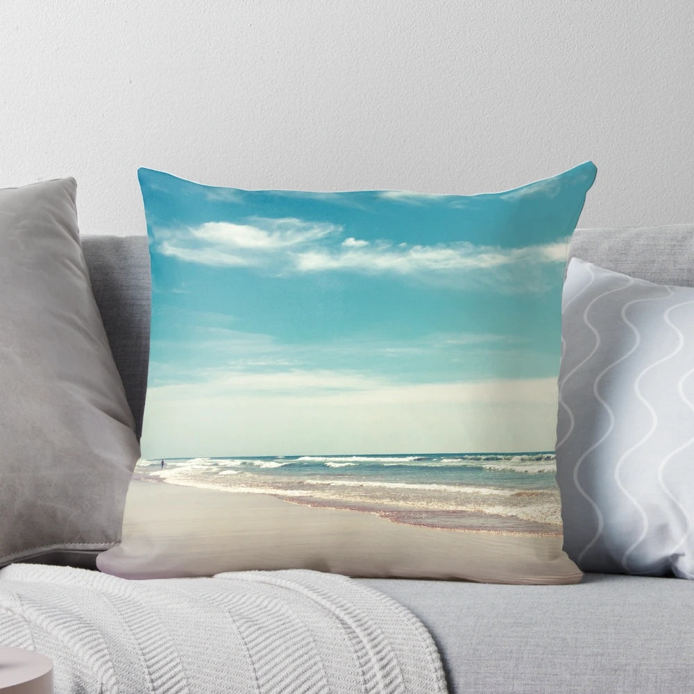 Soft, colorful pillow depicting a swimmer in a peaceful, tropical ocean scene.