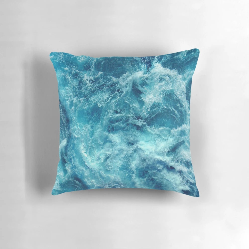 Closeup of a decorative pillow with a printed ocean wave design