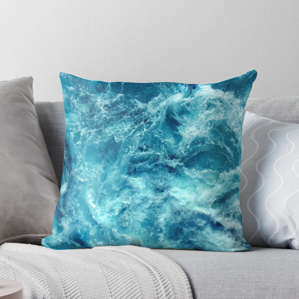 Closeup of a decorative pillow with a printed ocean wave design