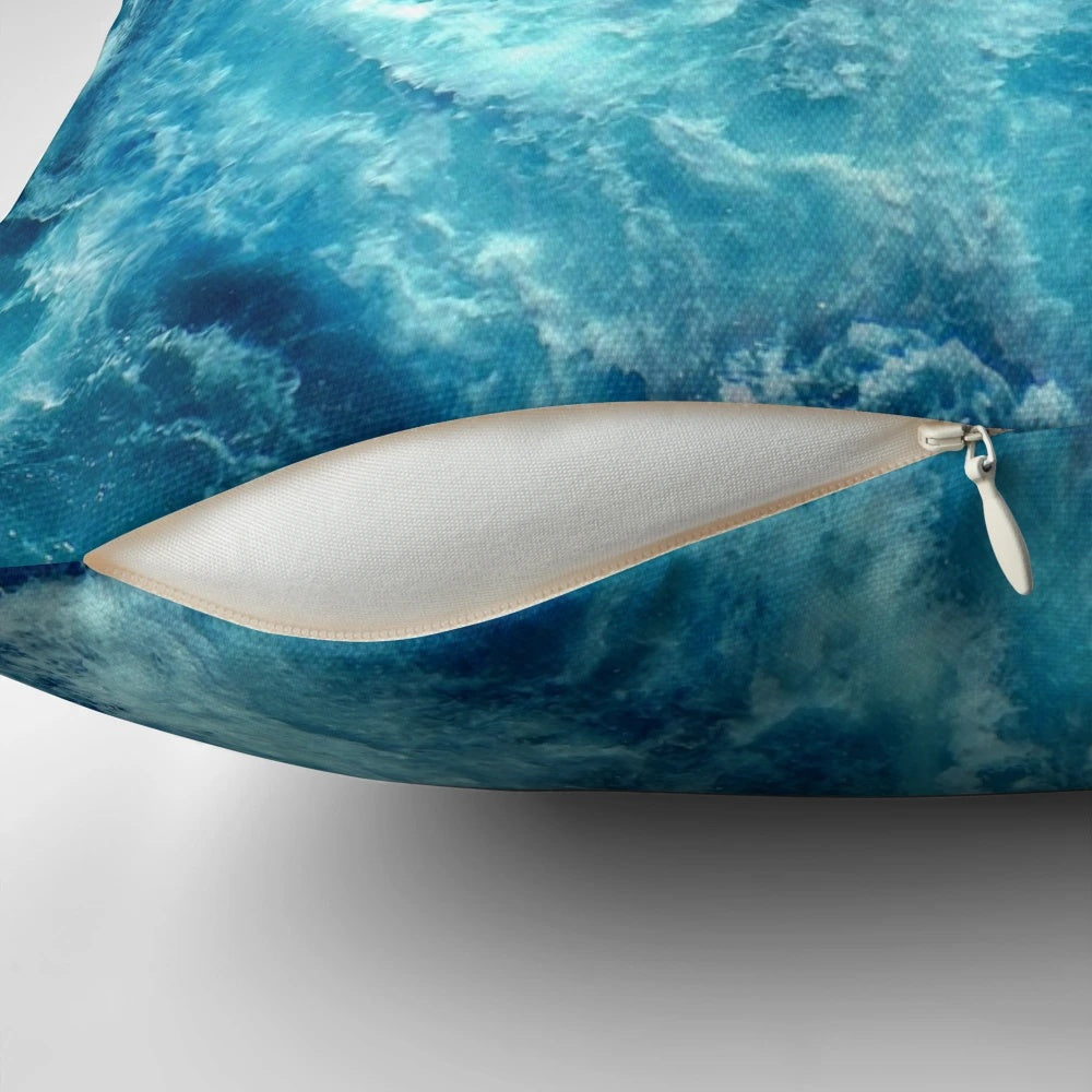 Closeup of a decorative pillow with a printed ocean wave design