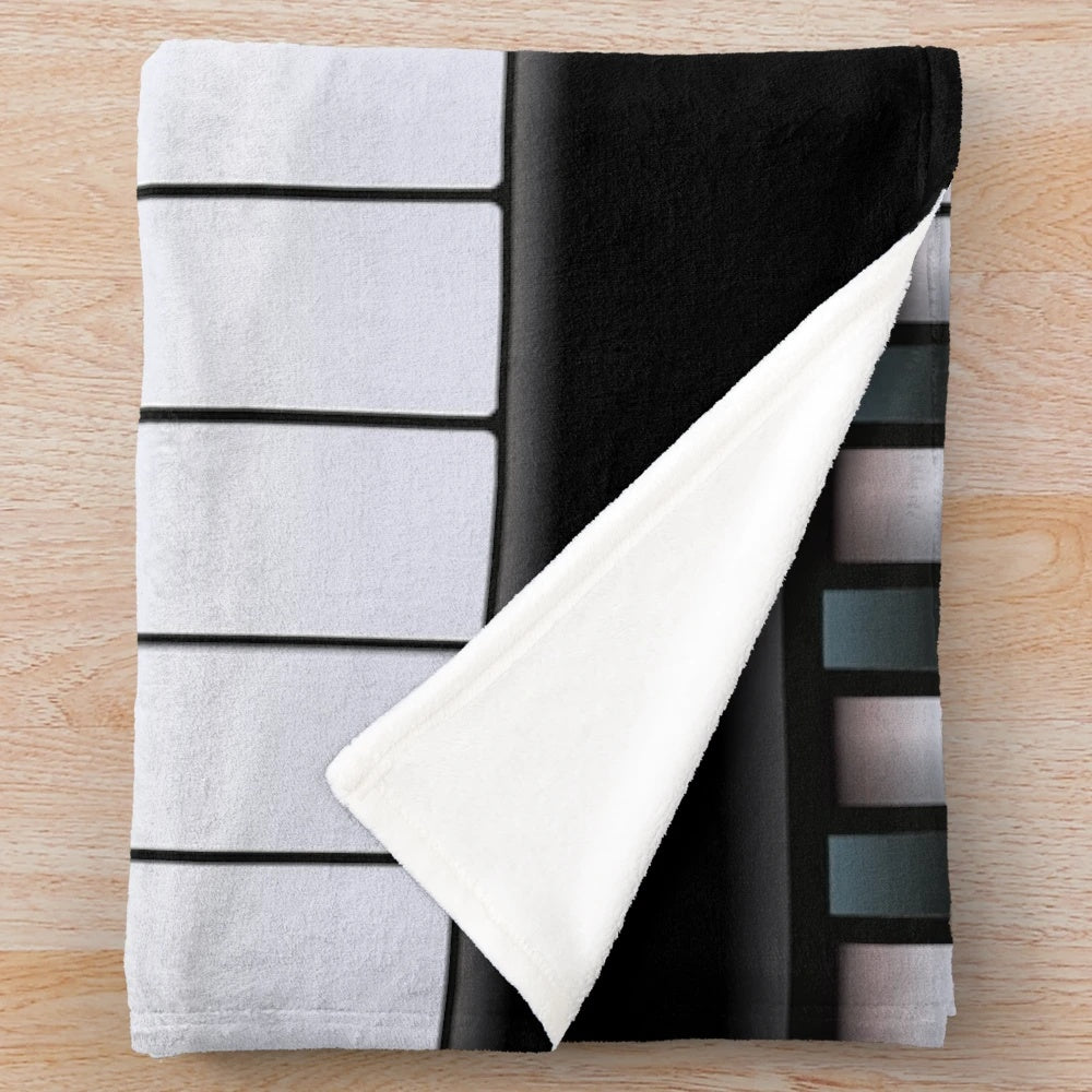Piano-themed plush blanket