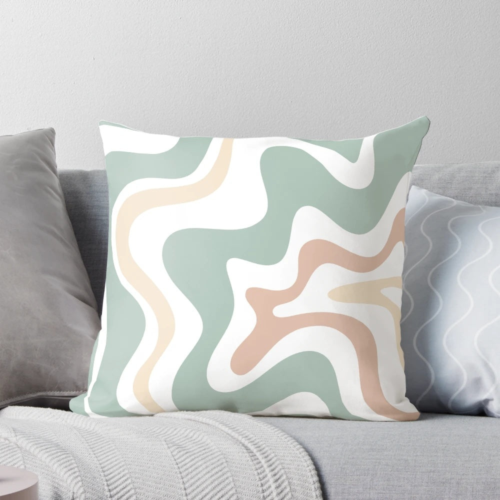 Soothing abstract pillow in light sage celadon green, light blush, and cream colors with a retro, swirling pattern