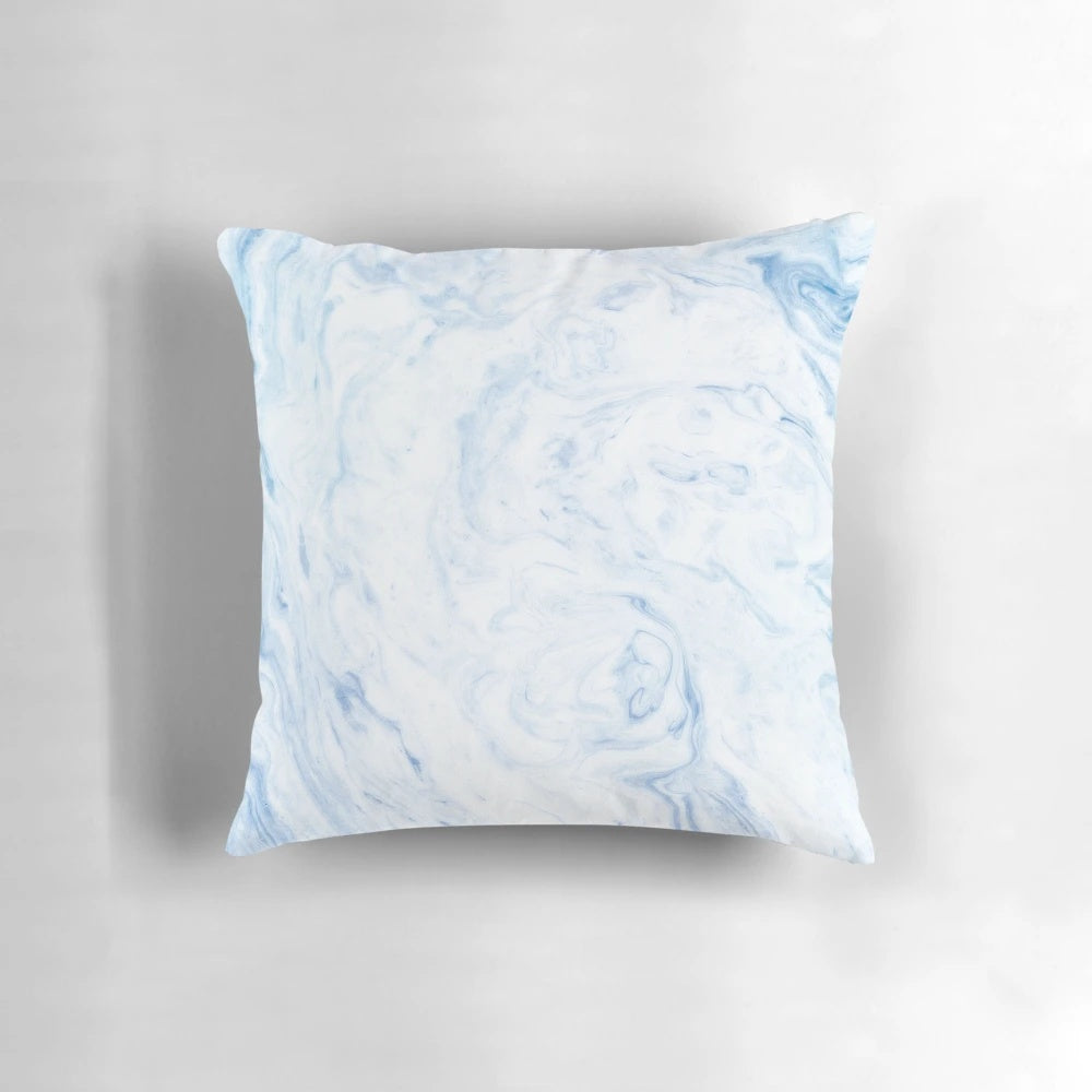 A cozy, sky blue marble-patterned pillow with a soft, watercolor-like design.