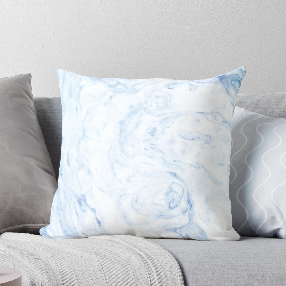 A cozy, sky blue marble-patterned pillow with a soft, watercolor-like design.