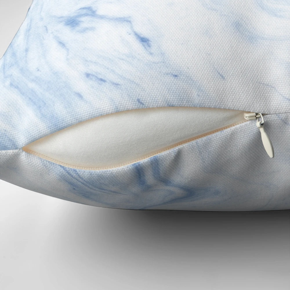 A cozy, sky blue marble-patterned pillow with a soft, watercolor-like design.