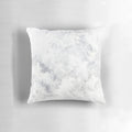 A serene white rabbit nestled in a captivating snowstorm, featured on a modern, minimalist pillow.