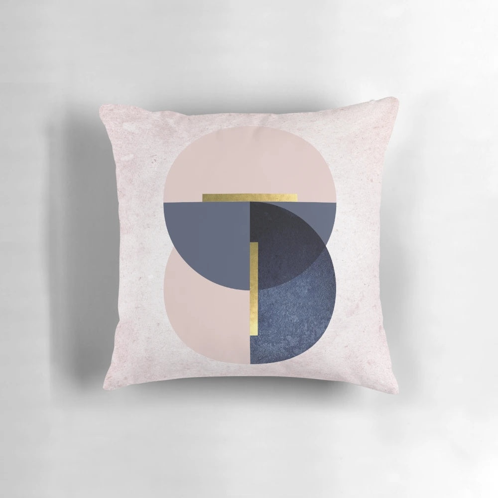 Overlapping circles pillow in pastel pink and navy blue, featuring a minimalist geometric design.