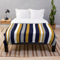 Vertical stripe plush blanket in mustard, navy, and gray colors