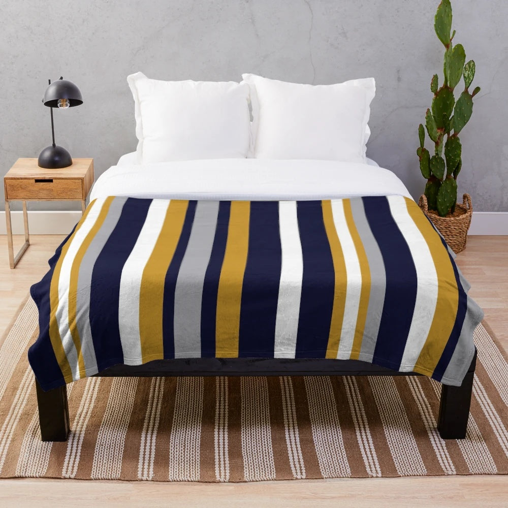 Vertical stripe plush blanket in mustard, navy, and gray colors