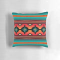 A colorful pillow featuring a Navajo-inspired geometric pattern in teal, orange, and neutral tones.