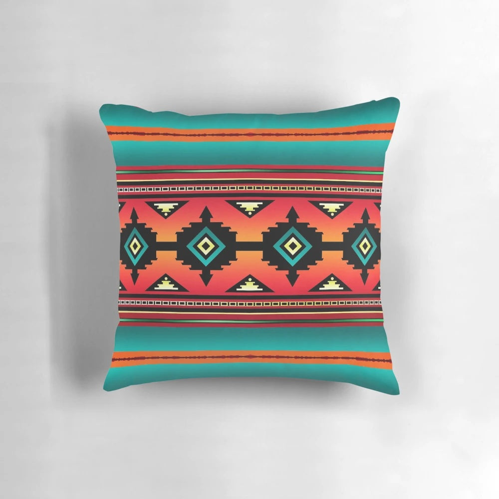 A colorful pillow featuring a Navajo-inspired geometric pattern in teal, orange, and neutral tones.
