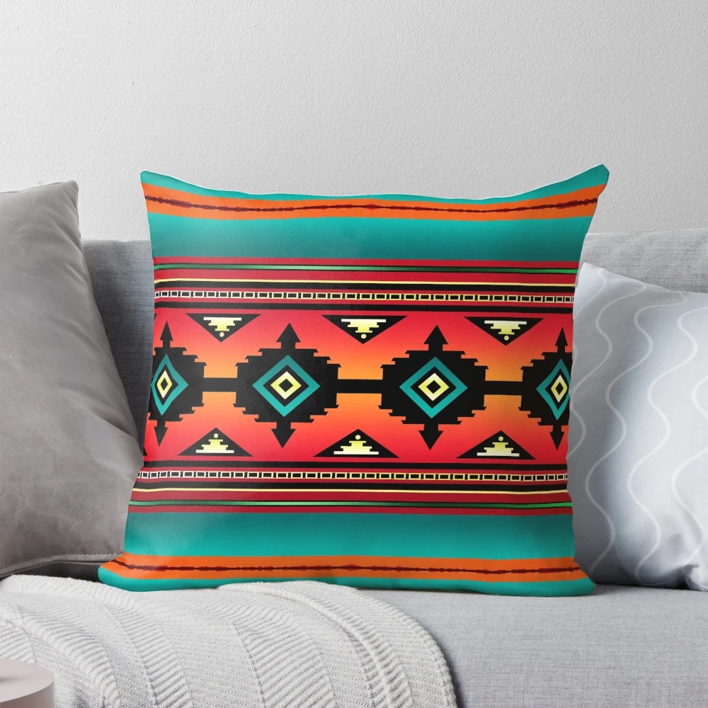 A colorful pillow featuring a Navajo-inspired geometric pattern in teal, orange, and neutral tones.