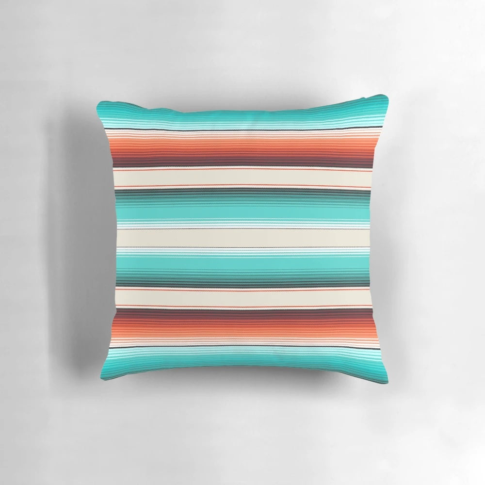 Decorative throw pillow featuring a southwest-inspired design with navajo white, turquoise, and burnt orange stripes