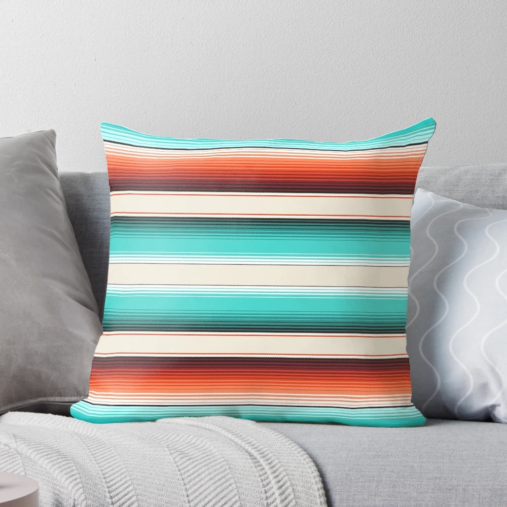 Decorative throw pillow featuring a southwest-inspired design with navajo white, turquoise, and burnt orange stripes