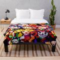 Southwestern-style plush blanket featuring colorful folklorico-inspired dolls