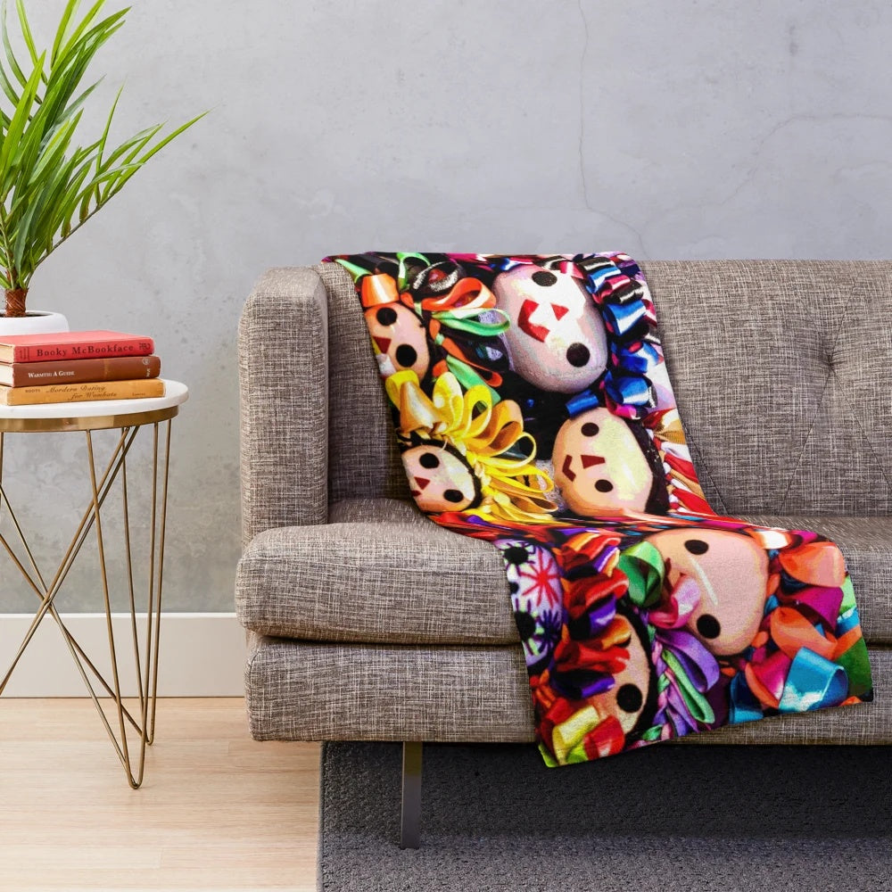 Southwestern-style plush blanket featuring colorful folklorico-inspired dolls
