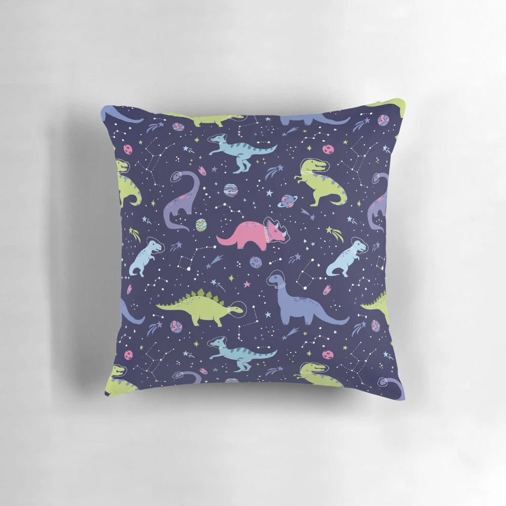 A pillow featuring a design of dinosaurs in a purple night sky with constellations and shooting stars.