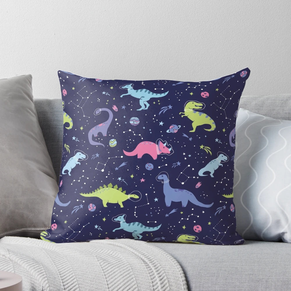 A pillow featuring a design of dinosaurs in a purple night sky with constellations and shooting stars.