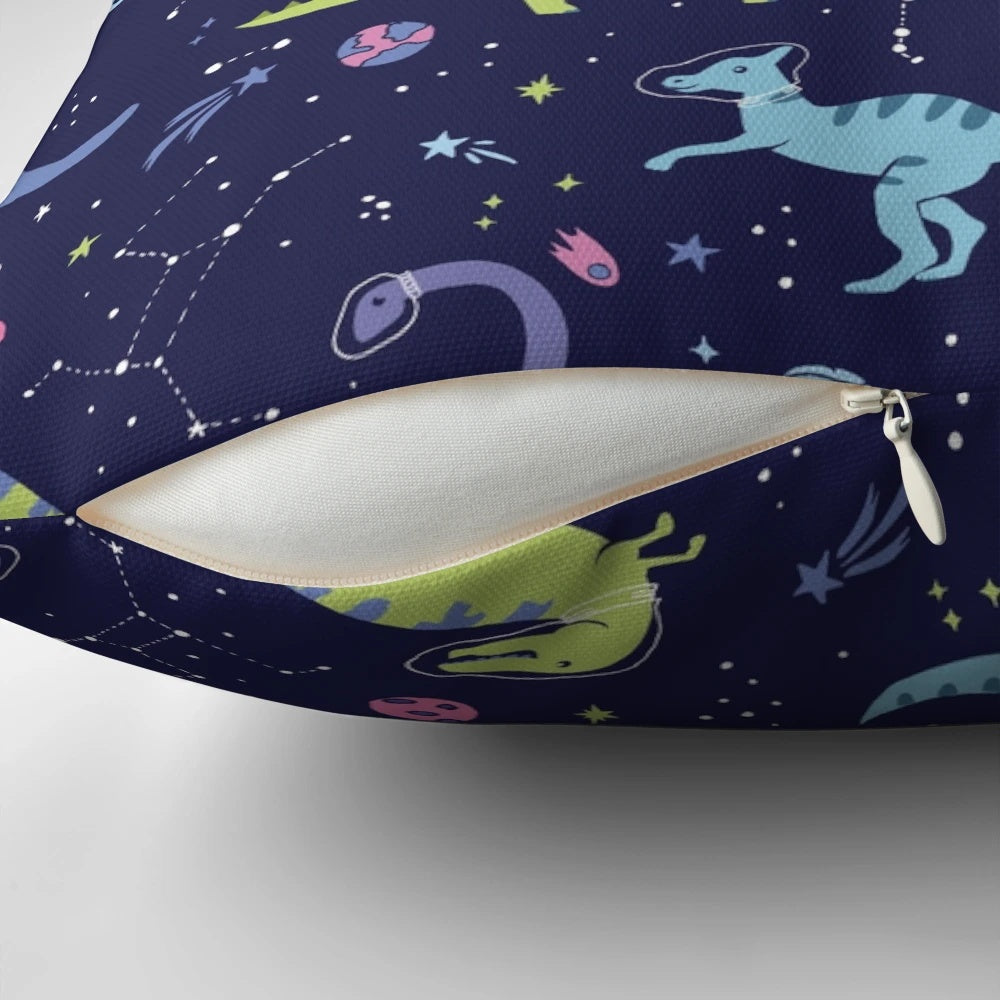 A pillow featuring a design of dinosaurs in a purple night sky with constellations and shooting stars.