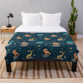 Plush dinosaur blanket with asteroid and star constellation pattern