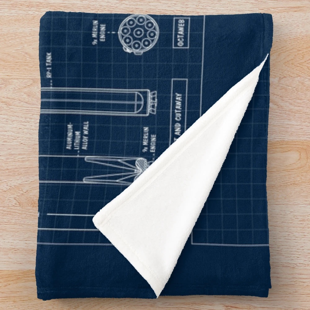 Plush blanket featuring a navy blueprint-style design of the SpaceX Falcon 9 rocket and Starship spacecraft