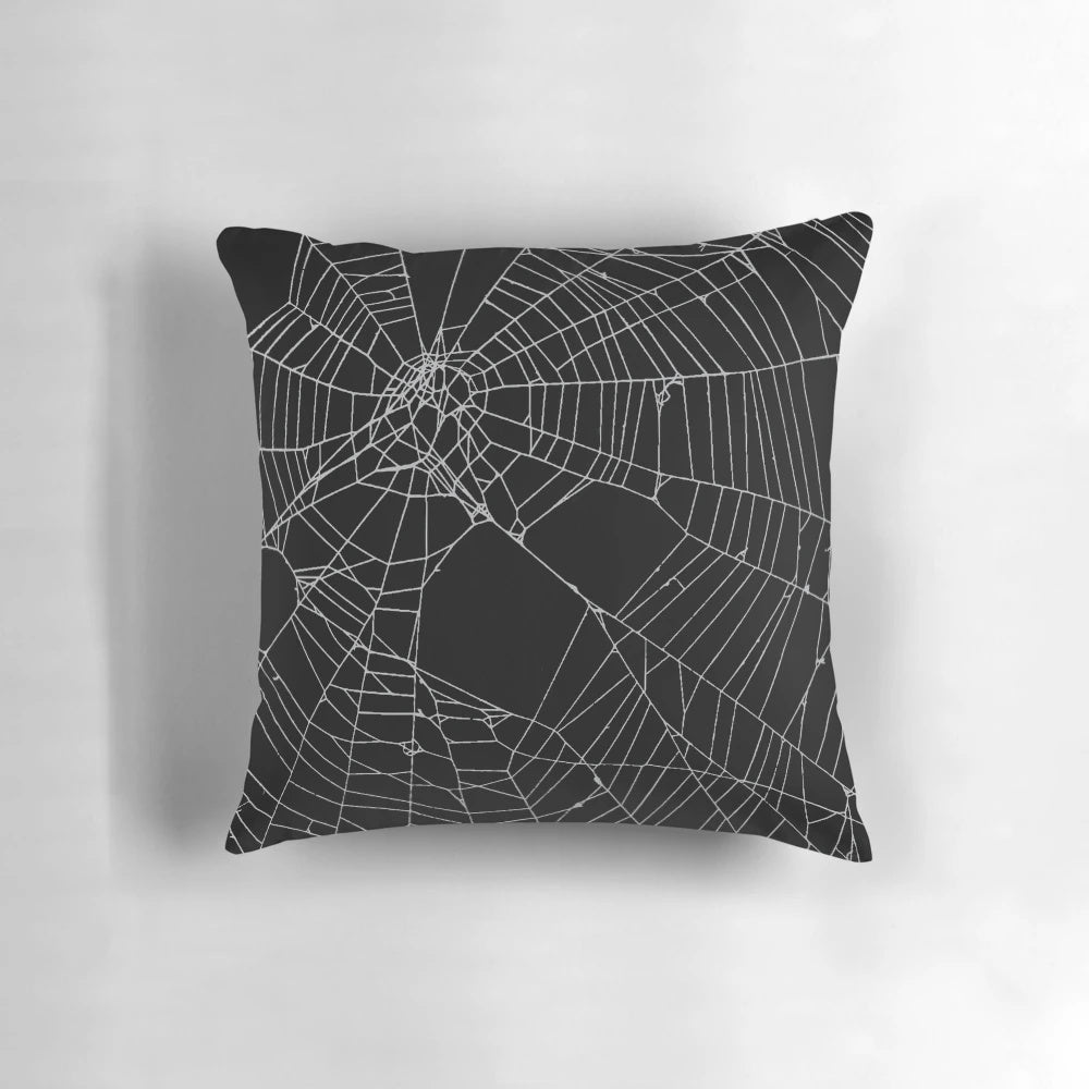 Black and white spiderweb pattern pillow with a detailed, distressed design.