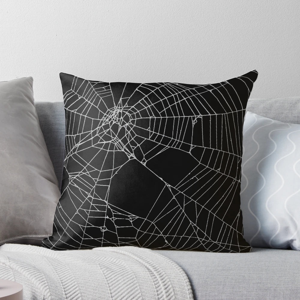 Black and white spiderweb pattern pillow with a detailed, distressed design.